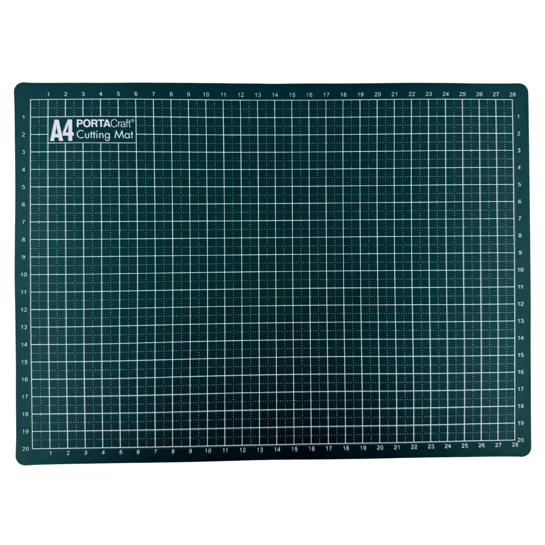 A dark green cutting mat with a white grid pattern and measurement markings from Porta Craft - Available at Discount Craft