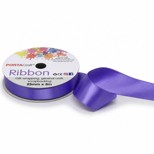 Purple ribbon spool white background