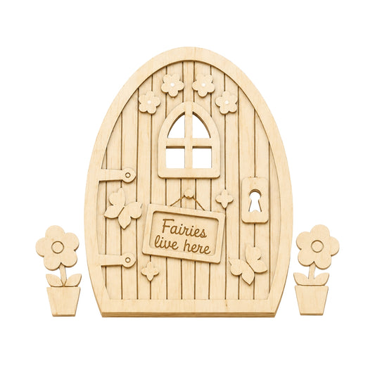 A wooden fairy door kit with an arched natural wood door featuring a window, decorative cutout flowers, a keyhole, and a sign that reads 'Fairies live here'. Two small flower pot cutouts are placed on either side of the door, all shown on a plain white background.